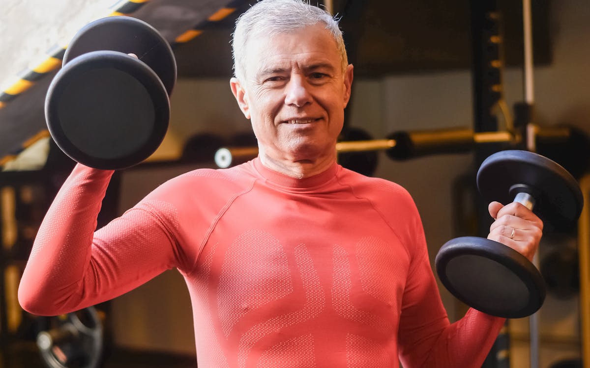 Mature man performing a resistance training exercise — strength building protocol for men over 40